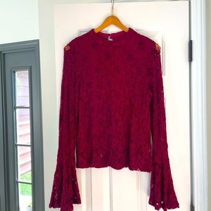 Lacey, flared wrist, maroon top.